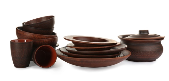 Set of stylish clay dishes on white background