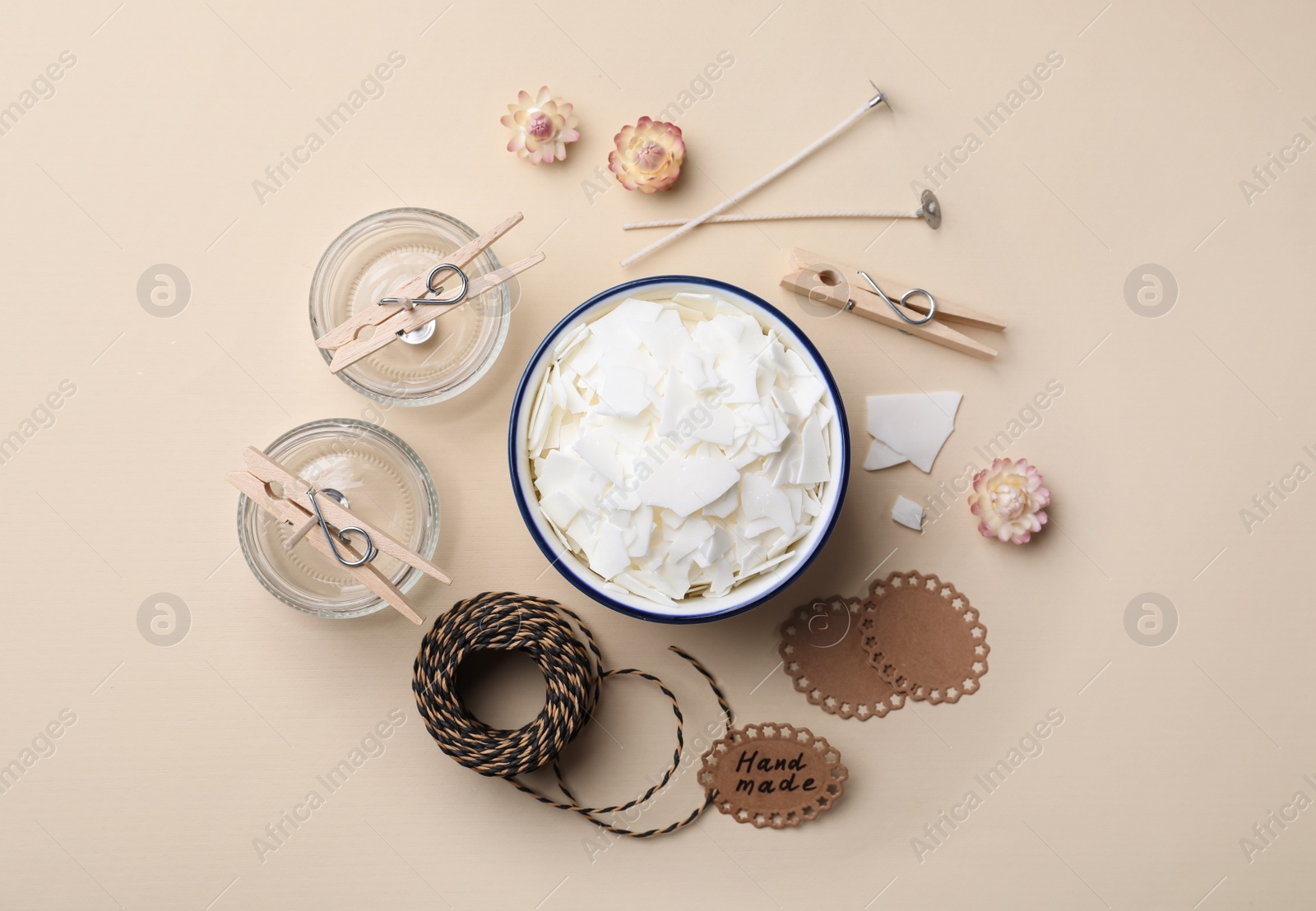 Photo of Flat lay composition with ingredients for homemade candles on beige background