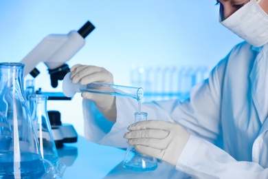 Female scientist working with liquids in laboratory. Chemical analysis