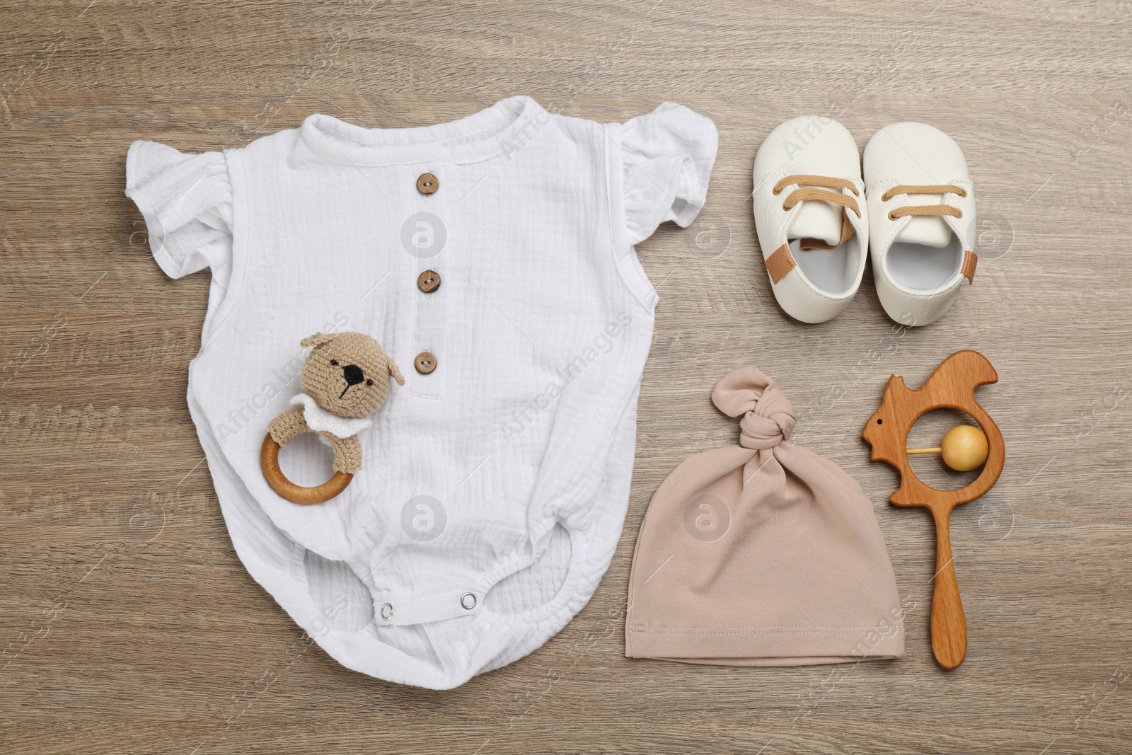 Photo of Flat lay composition with baby clothes and accessories on wooden table