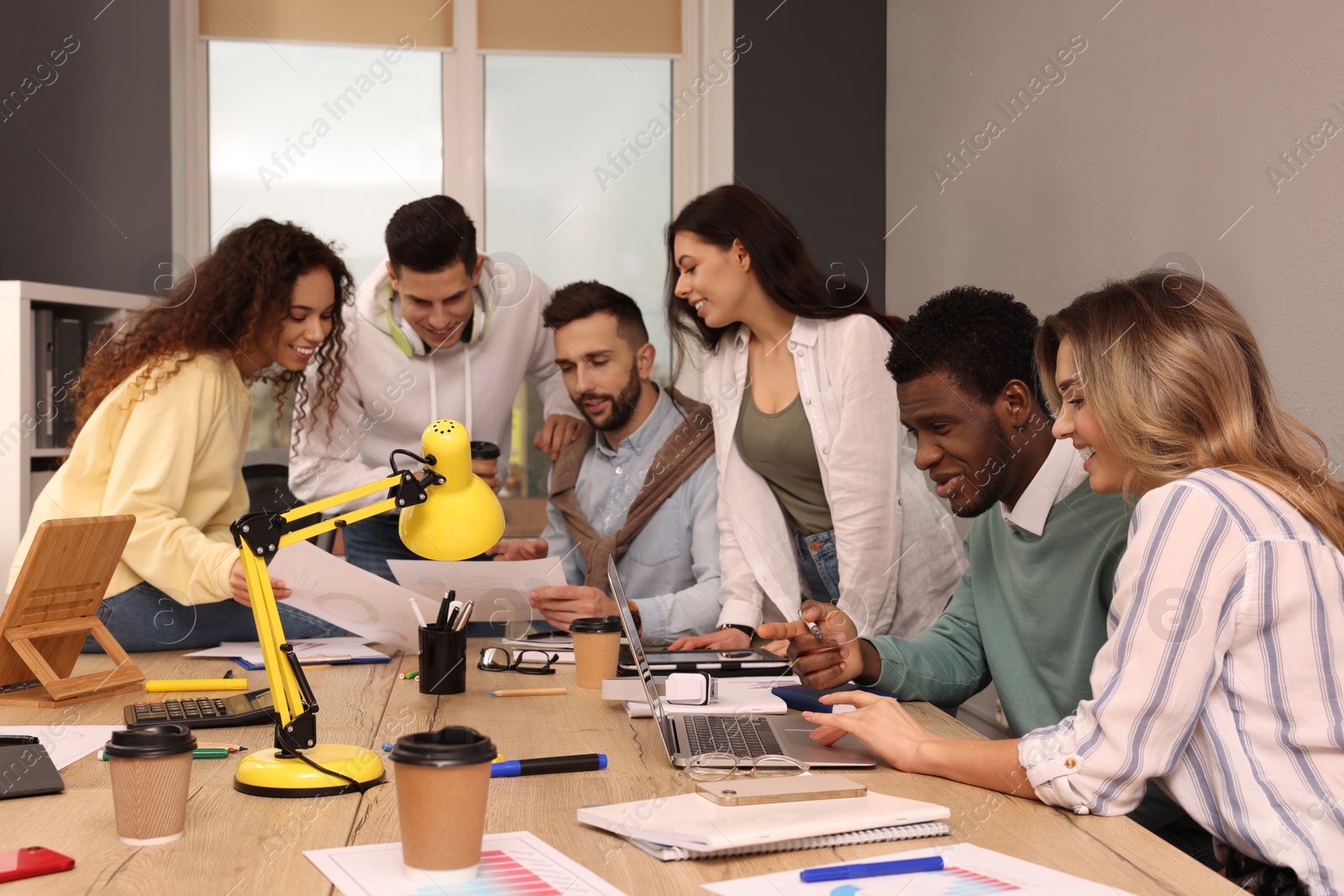 Photo of Team of employees working together in office. Startup project