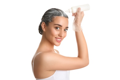 Photo of Young woman dyeing her hair against white background