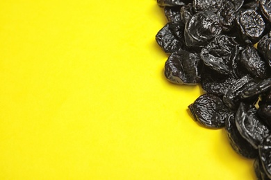 Photo of Tasty prunes on color background, top view with space for text. Dried fruit as healthy snack