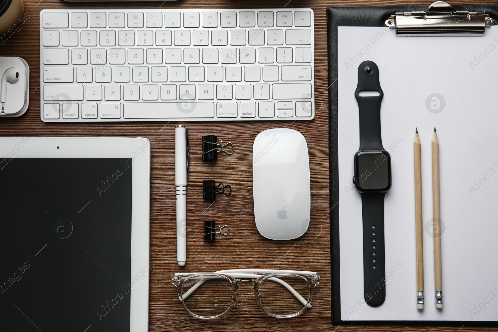 Photo of MYKOLAIV, UKRAINE - JULY 20, 2020: Flat lay composition with different Apple gadgets on wooden table