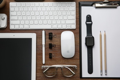 MYKOLAIV, UKRAINE - JULY 20, 2020: Flat lay composition with different Apple gadgets on wooden table