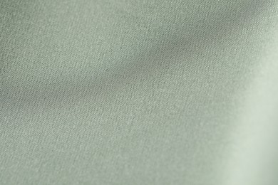 Photo of Texture of light green fabric as background, closeup