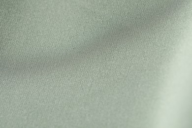 Texture of light green fabric as background, closeup