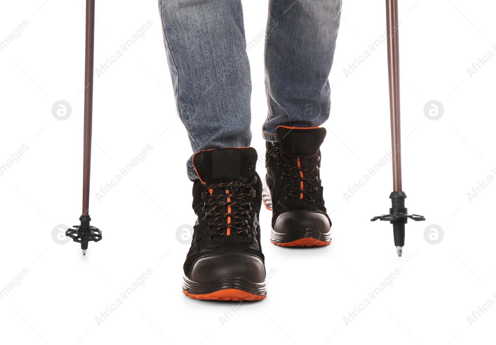 Photo of Man wearing stylish hiking boots with trekking poles on white background, closeup