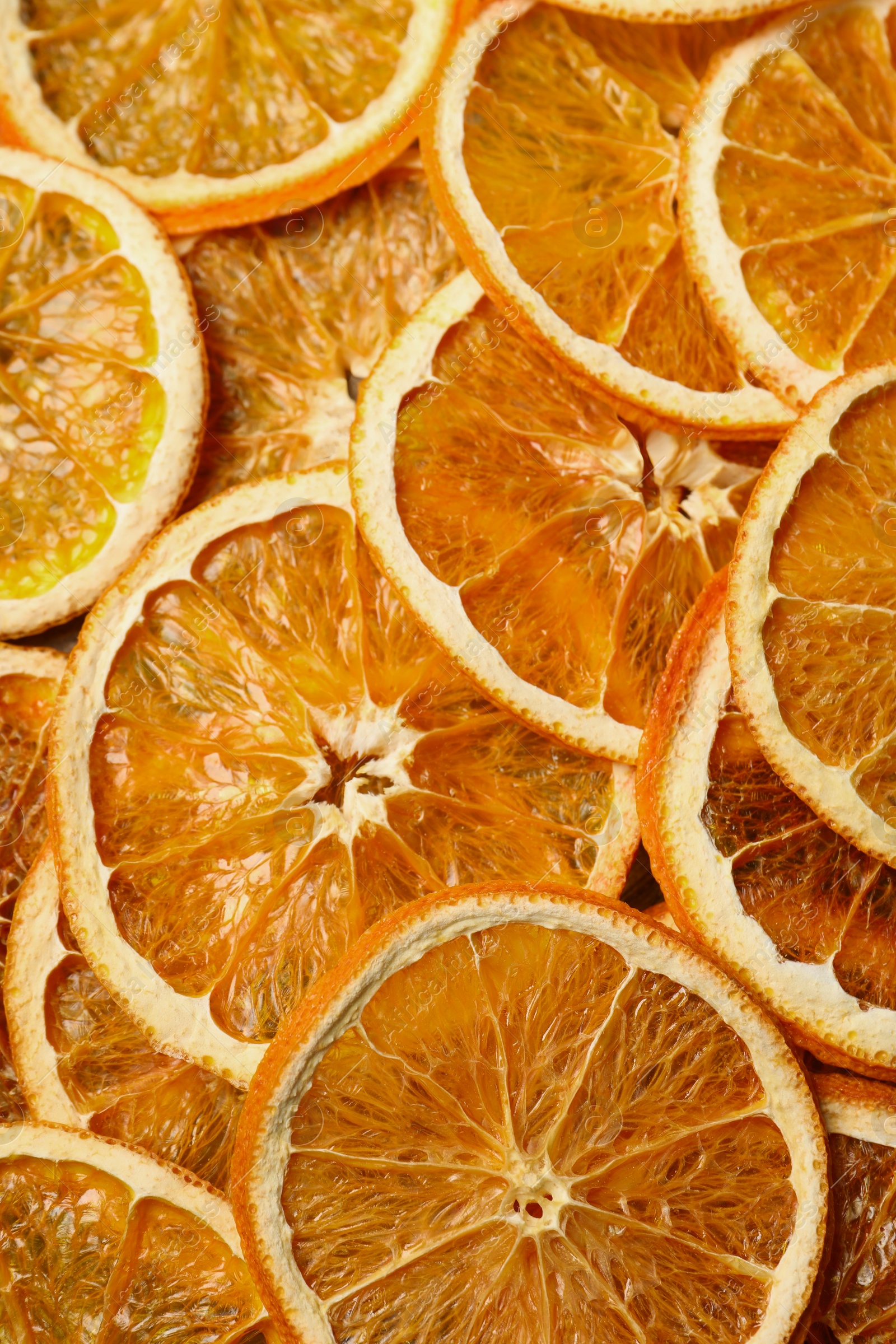 Photo of Heap of dry orange slices as background, top view