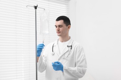 Photo of Doctor setting up IV drip in hospital