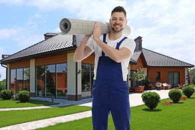 Image of Worker with rolled carpet outdoors on sunny day