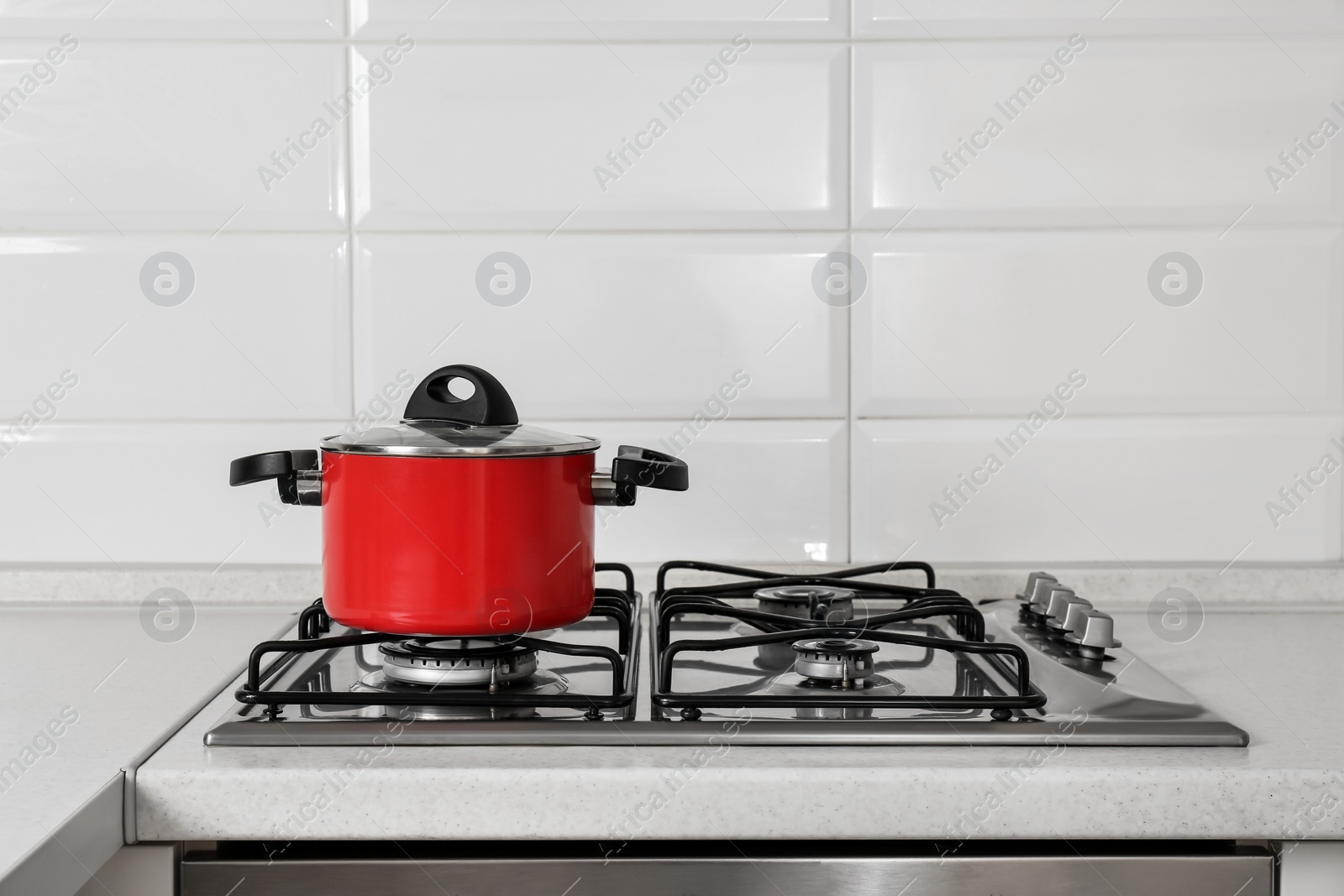 Photo of Red pot on gas stove in kitchen