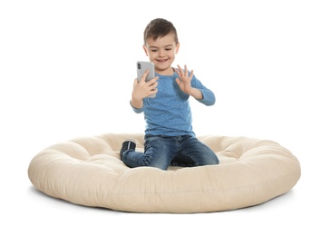 Photo of Little boy using video chat on smartphone, white background