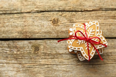 Photo of Tasty Christmas cookies with icing on wooden table, top view. Space for text