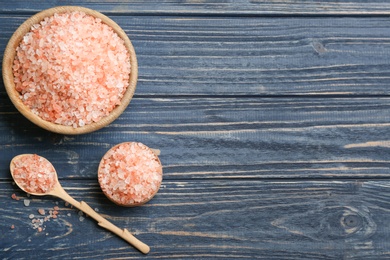 Photo of Pink himalayan salt on blue wooden table, flat lay. Space for text