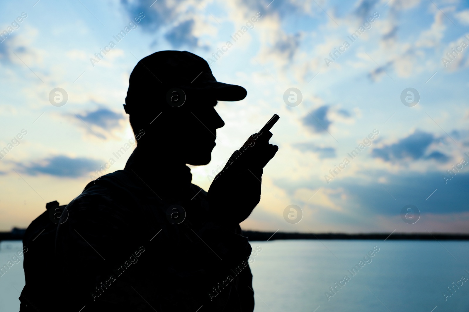 Photo of Soldier with portable radio transmitter outdoors. Military service