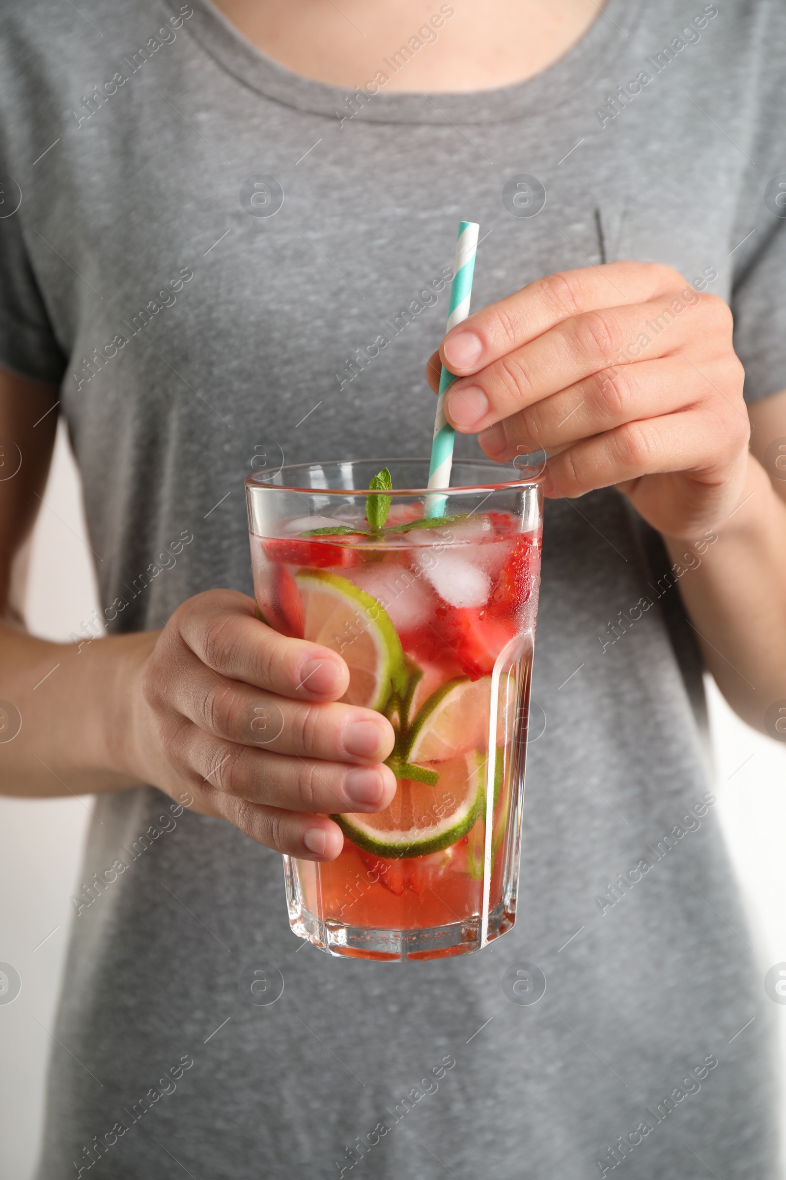 Photo of Young woman with glass of tasty refreshing drink, closeup