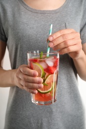 Photo of Young woman with glass of tasty refreshing drink, closeup