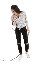 Photo of Young woman wearing casual clothes singing in microphone on white background