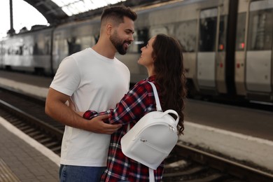 Long-distance relationship. Beautiful couple on platform of railway station