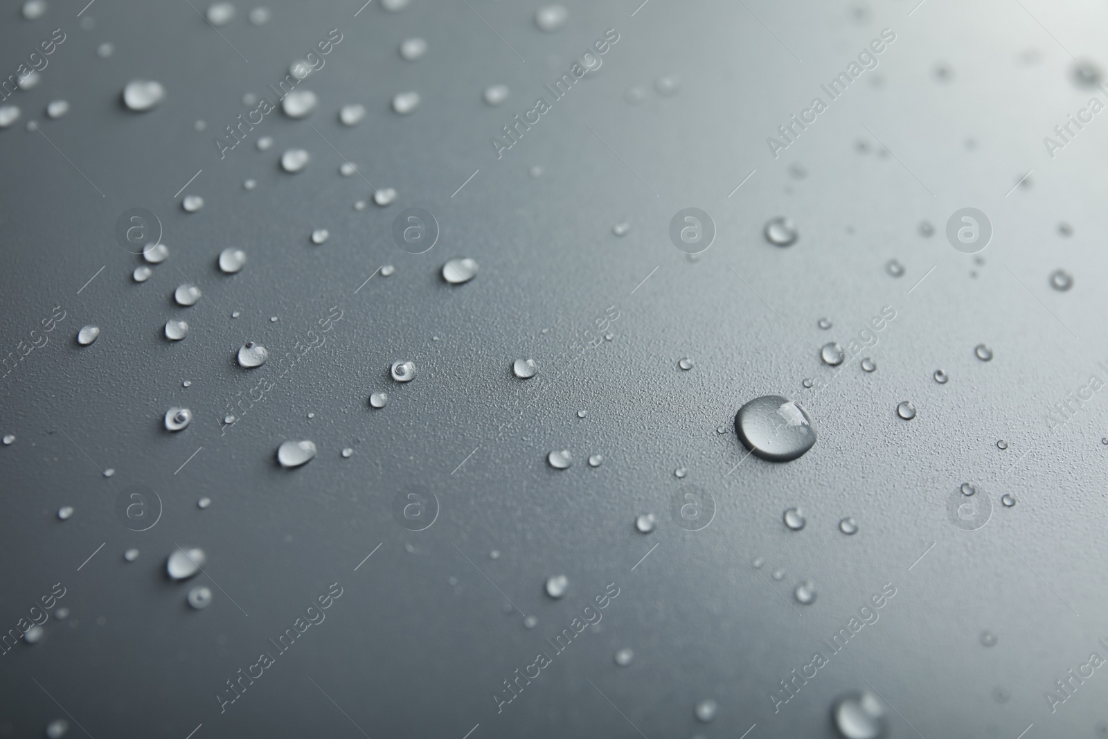 Photo of Many clean water drops on grey background