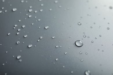 Many clean water drops on grey background