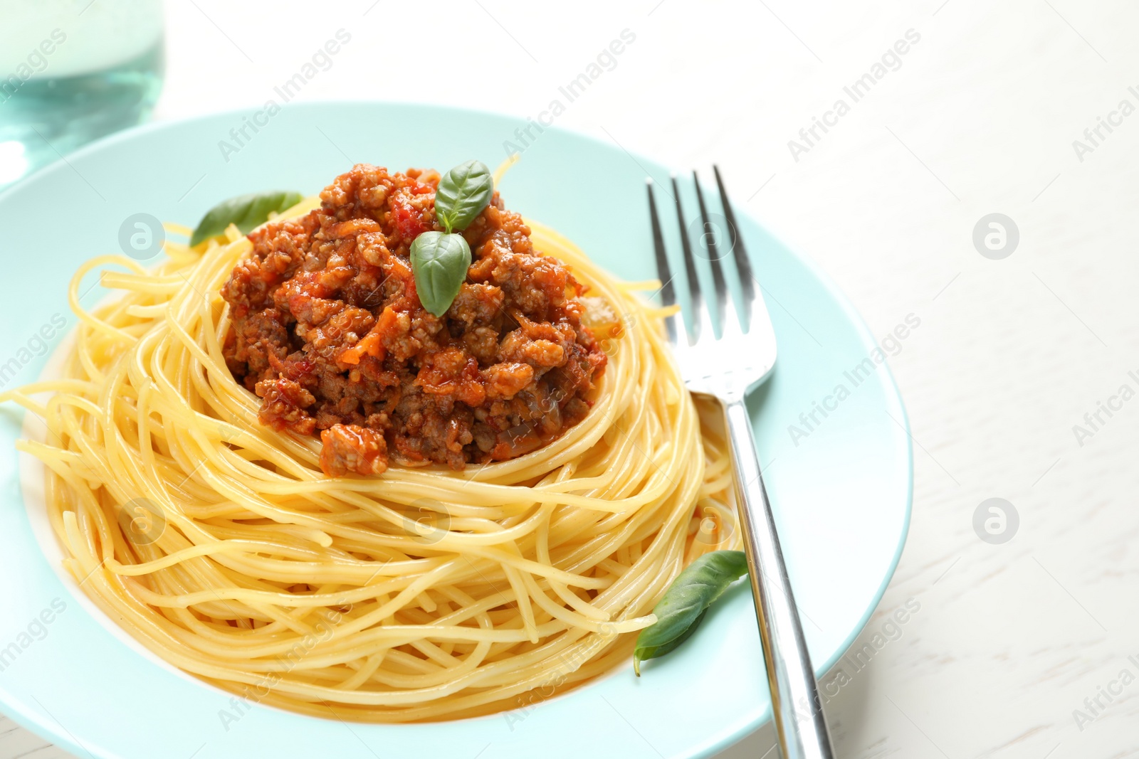 Photo of Plate with delicious pasta bolognese on table