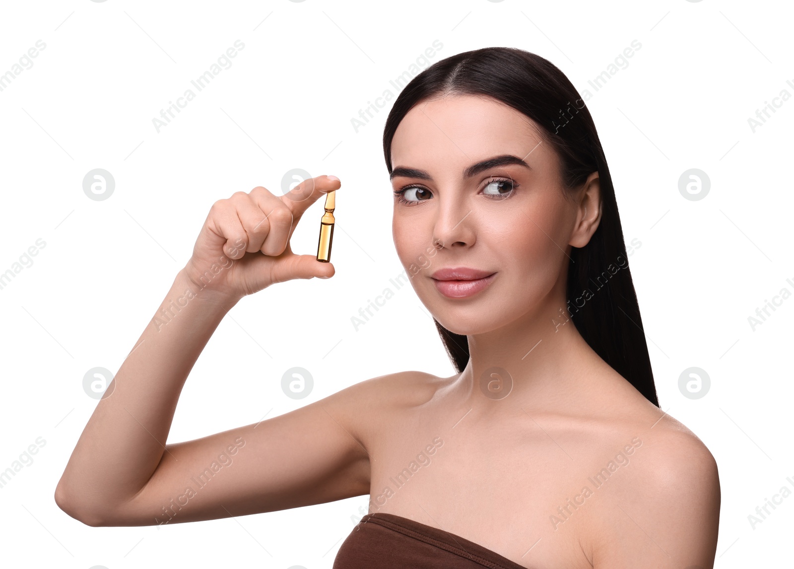 Photo of Beautiful young woman holding skincare ampoule on white background