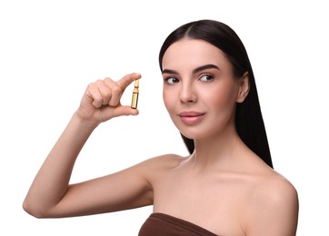 Beautiful young woman holding skincare ampoule on white background