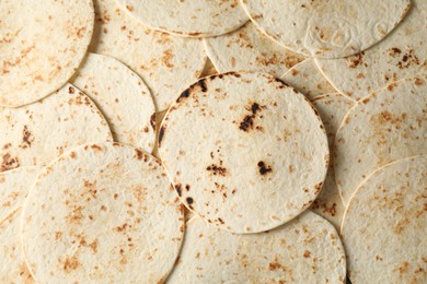 Photo of Many tasty homemade tortillas as background, top view