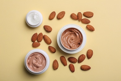 Flat lay composition with jars of body cream on beige background