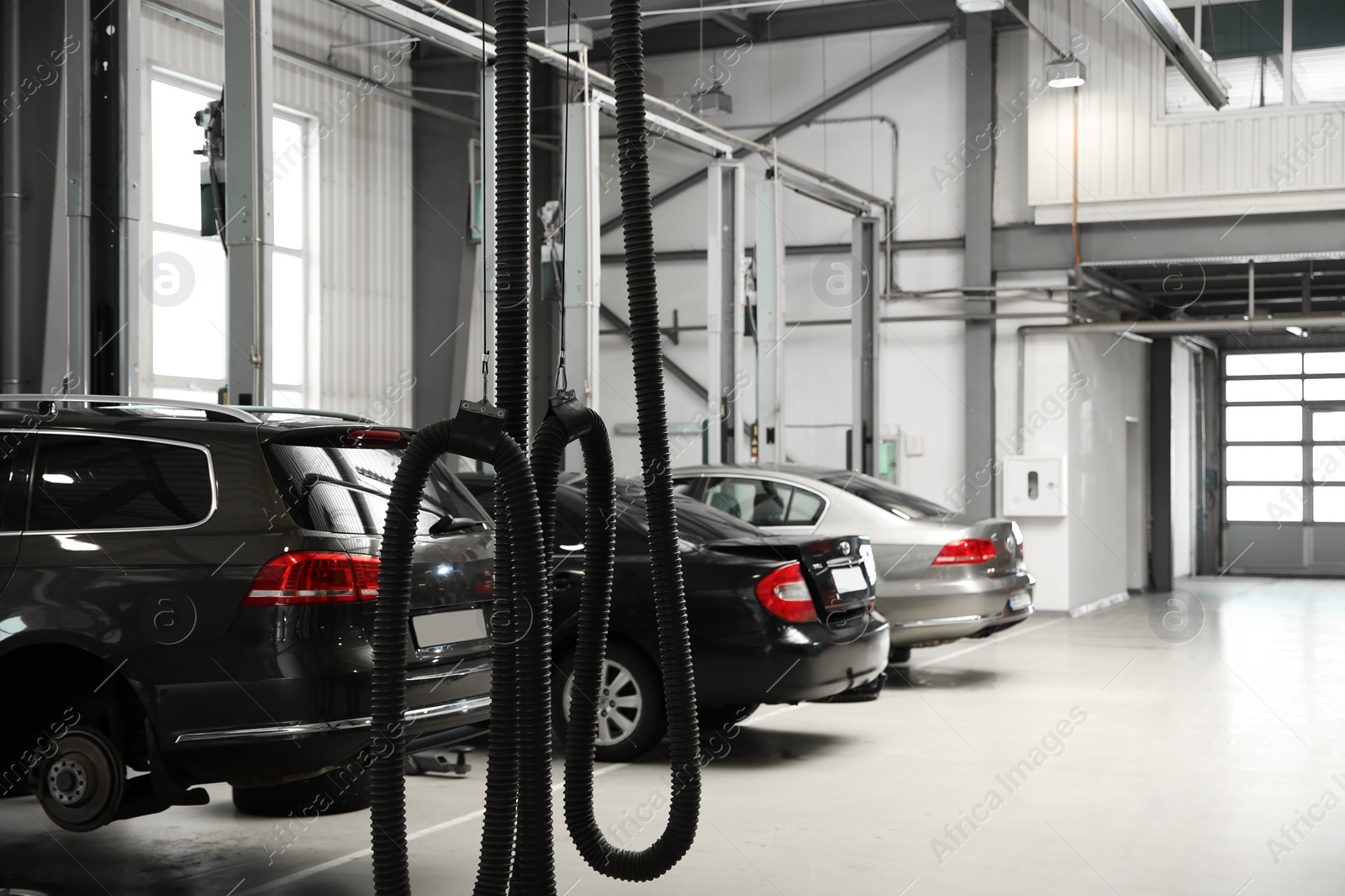 Photo of View of modern automobile repair shop with cars