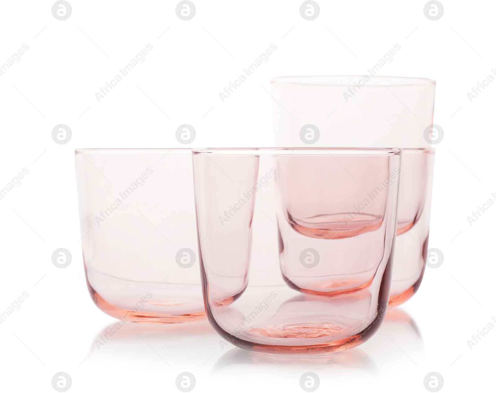 Photo of Empty elegant colorful whiskey glasses on white background