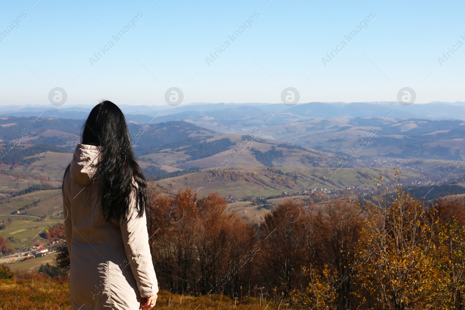 Photo of Woman in warm clothes enjoying mountain landscape