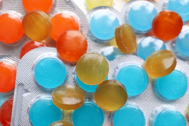 Photo of Many colorful cough drops as background, closeup