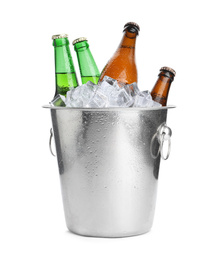 Metal bucket with bottles of beer and ice cubes isolated on white