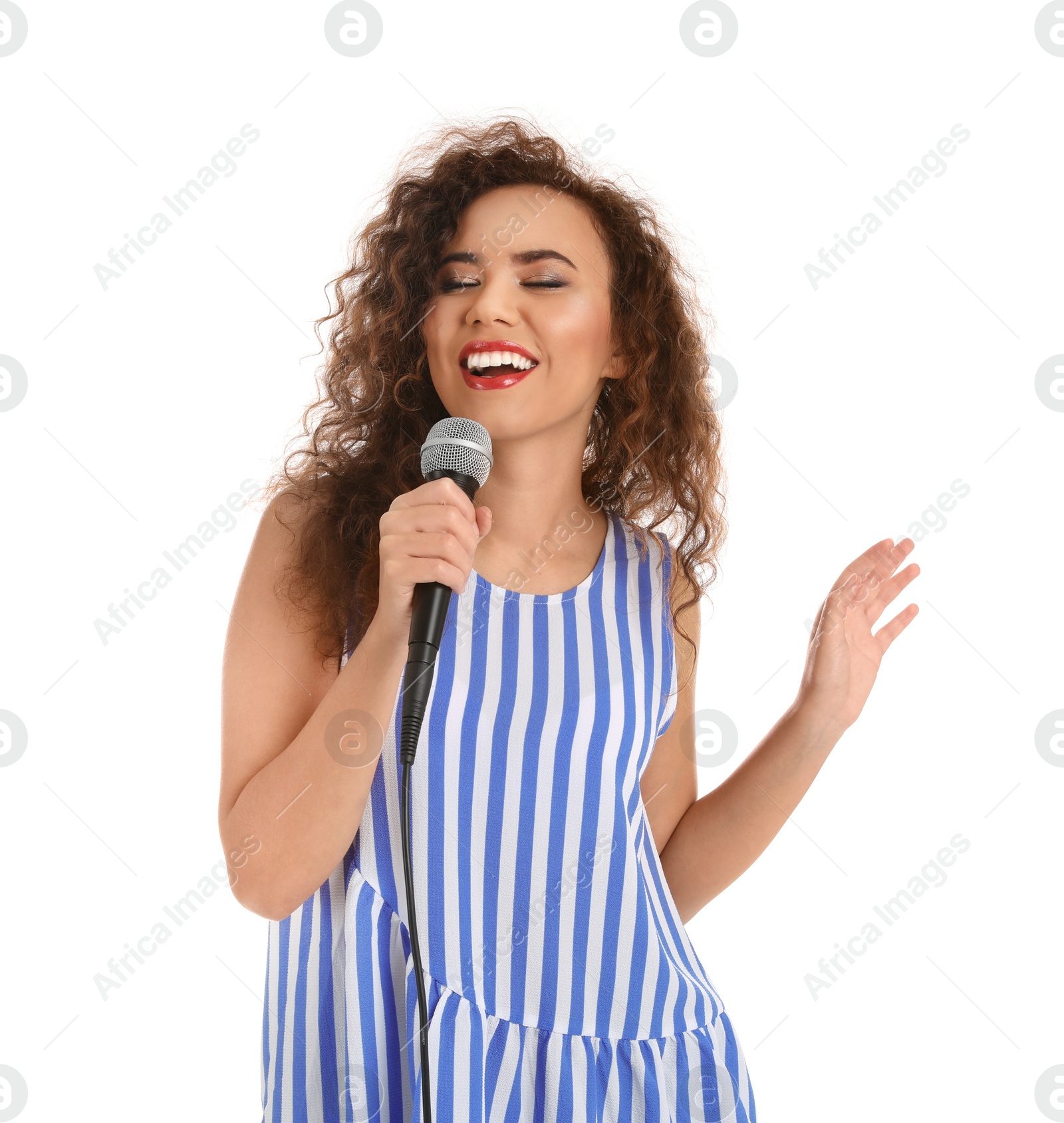 Photo of Curly African-American woman in casual clothes singing with microphone on white background