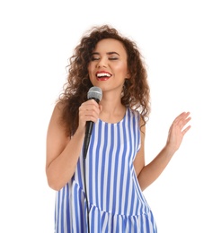 Curly African-American woman in casual clothes singing with microphone on white background