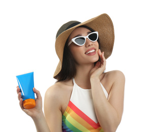 Photo of Young woman with sun protection cream on white background