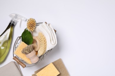 Flat lay composition with different cleaning supplies on white background, space for text