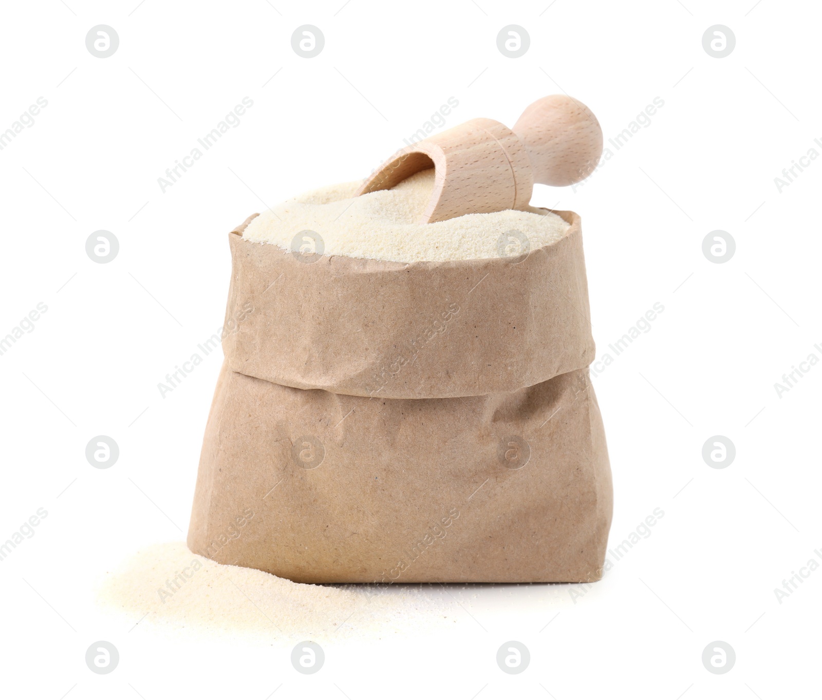 Photo of Uncooked organic semolina in paper bag and scoop isolated on white