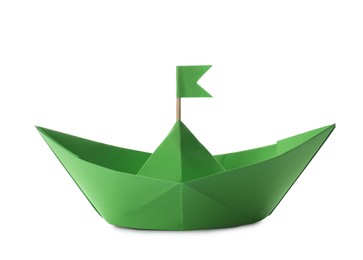 Photo of Handmade green paper boat with flag isolated on white. Origami art