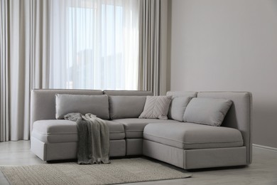 Large grey sofa in living room. Interior design