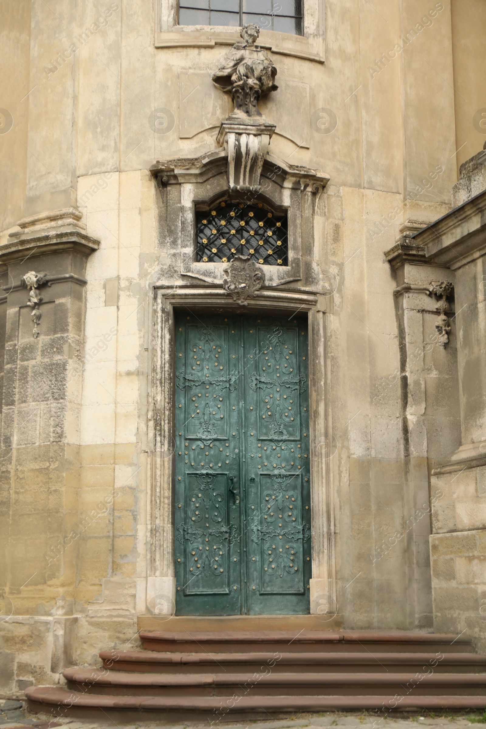 Photo of View of old building with wooden door. Exterior design