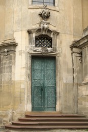View of old building with wooden door. Exterior design