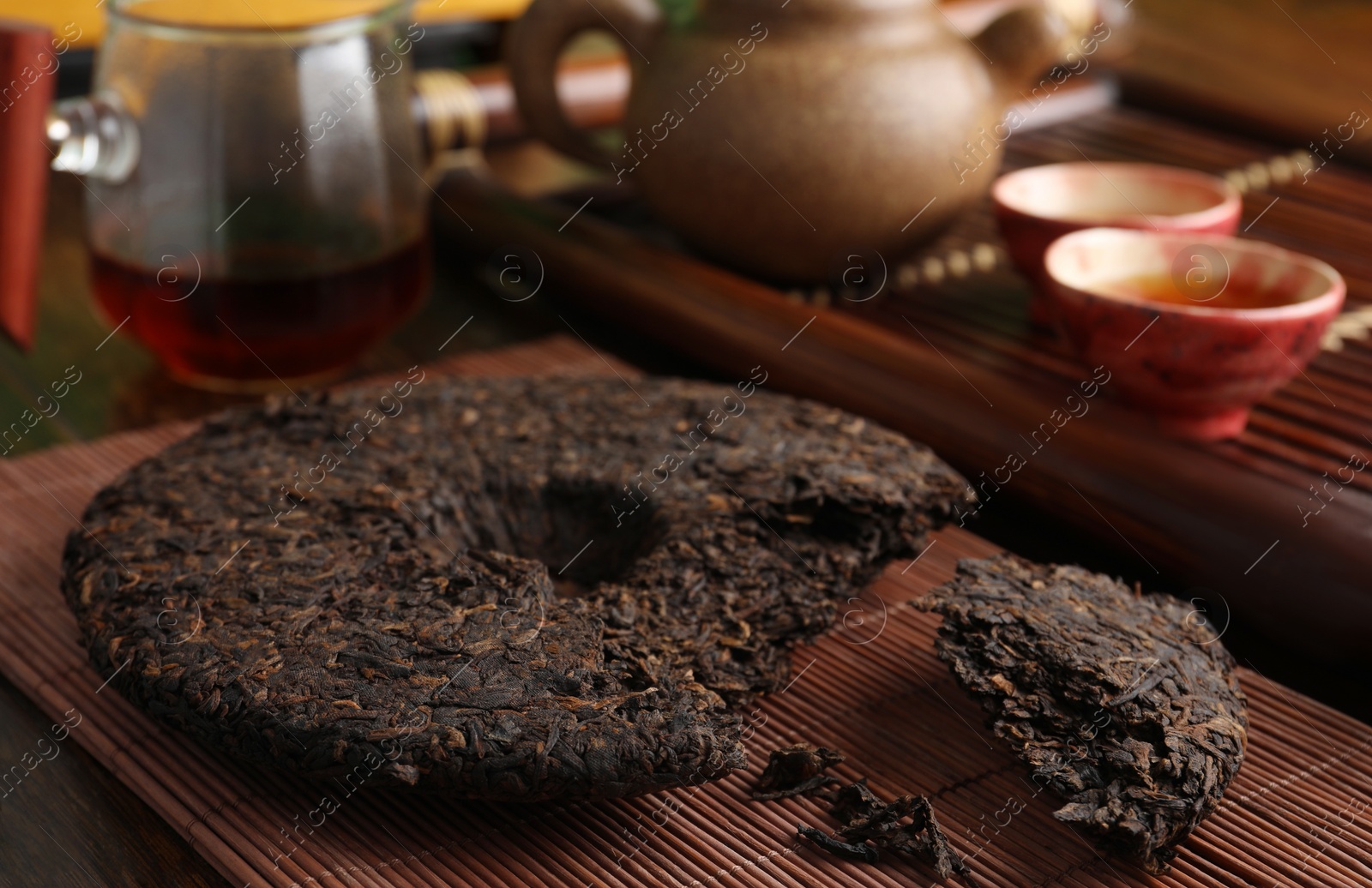 Photo of Broken disc shaped pu-erh tea on wooden table