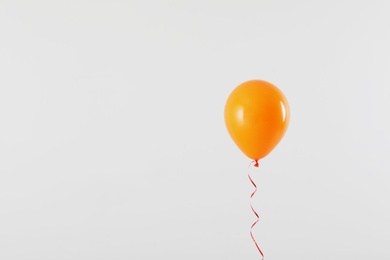 Photo of Bright balloon on light background, space for text. Celebration time