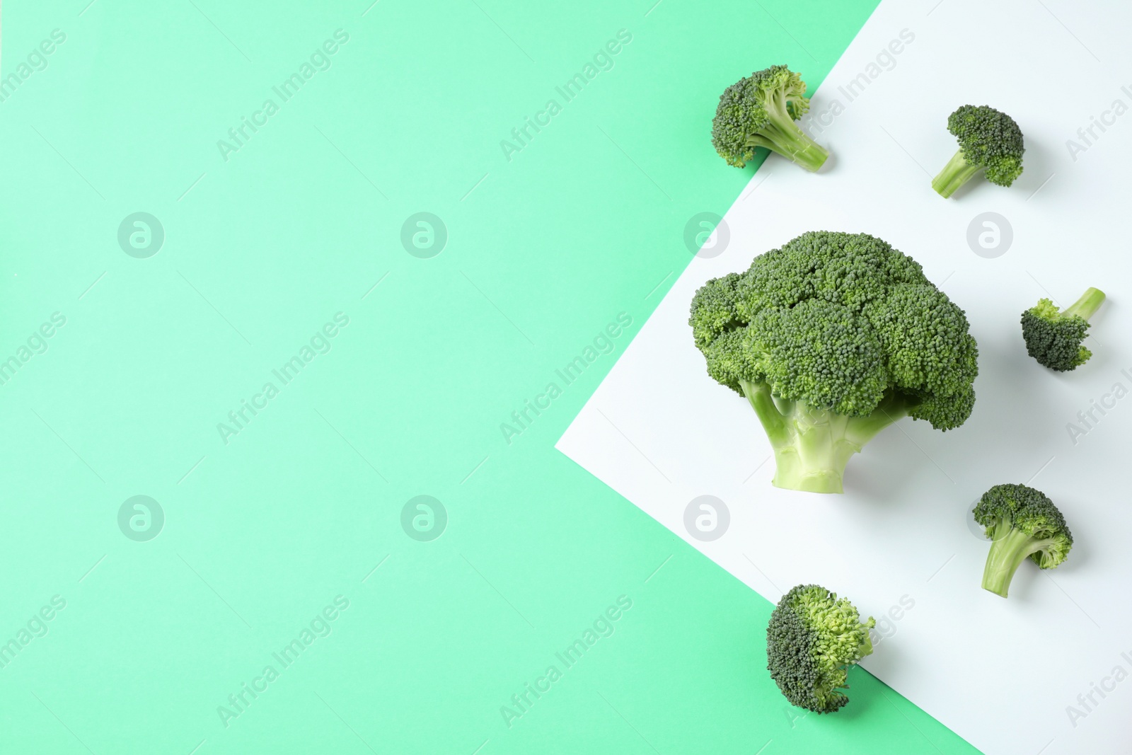 Photo of Fresh tasty broccoli on color background, flat lay