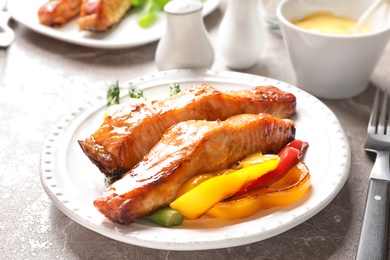 Tasty cooked salmon with vegetables on plate