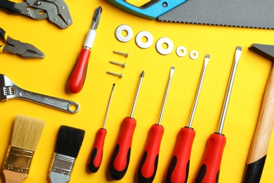 Photo of Flat lay composition with construction tools on color background